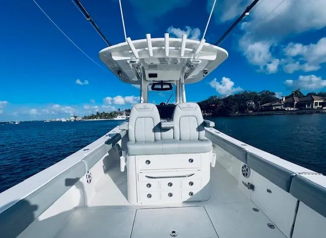 Slide: The Image of 2021 Regulator 34 boat interior with dual seats on a sunny day. - 20