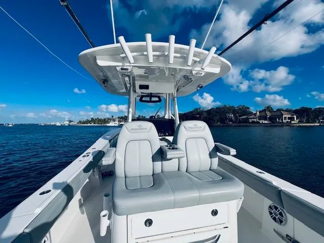 Slide: The Image of 2021 Regulator 34 boat interior with dual seats on a sunny day. - 22