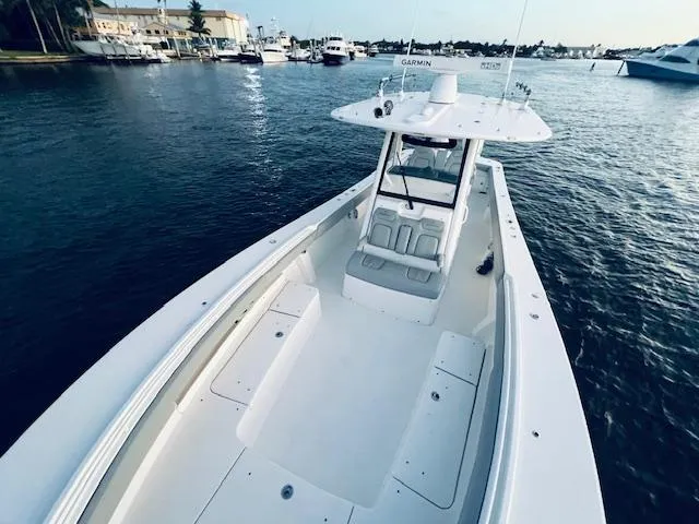 Slide: The Image of 2021 Regulator 34 boat on water, featuring spacious deck and modern design. - 27