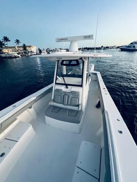 Slide: The Image of 2021 Regulator 34 boat on water, featuring spacious deck and Garmin equipment. - 28