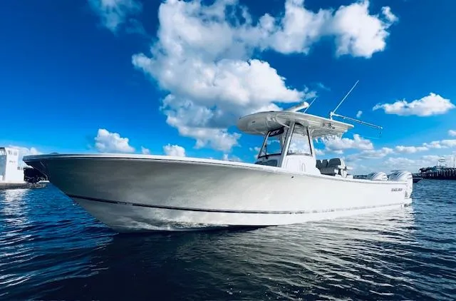Slide: The Image of 2021 Regulator 34 boat on water under blue sky with clouds. - 3