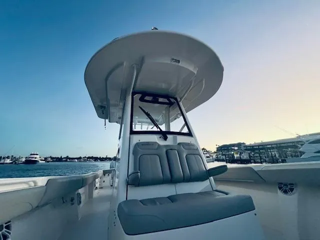 Slide: The Image of 2021 Regulator 34 boat with seating, docked at marina during sunset. - 30