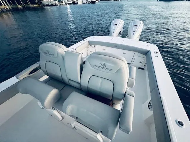 Slide: The Image of 2021 Regulator 34 boat with dual engines on calm water. - 34