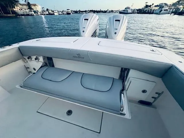 Slide: The Image of 2021 Regulator 34 boat with dual engines, featuring a spacious seating area on the water. - 36