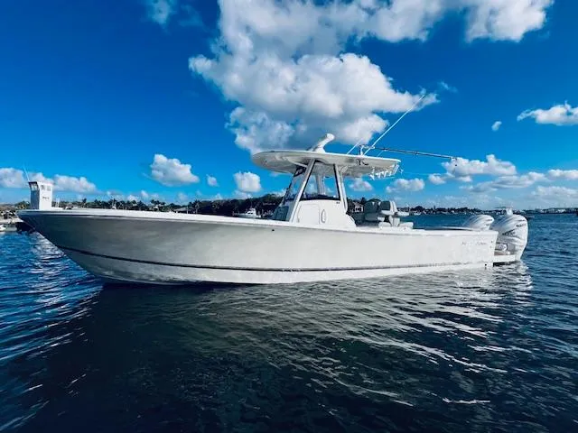 Slide: The Image of 2021 Regulator 34 boat on water under blue sky with clouds. - 4