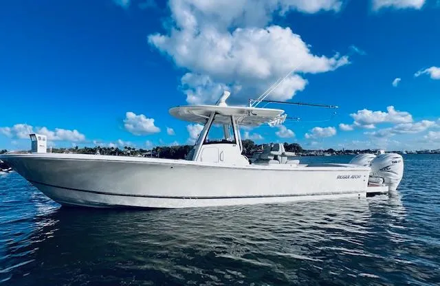 Slide: The Image of 2021 Regulator 34 boat on calm water under a clear blue sky. - 5