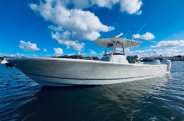 Slide: The Image of 2021 Regulator 34 boat on water under blue sky with clouds. - 6