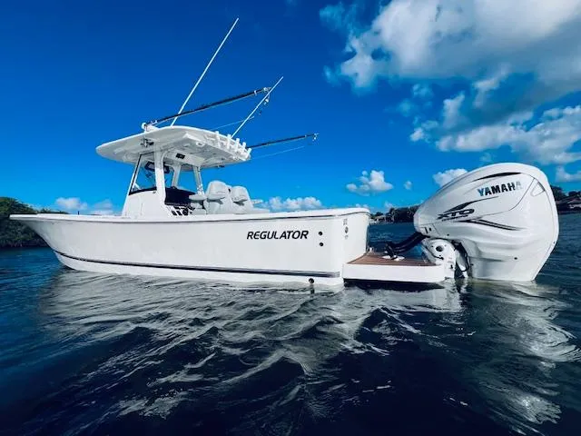 Slide: The Image of 2021 Regulator 34 boat with Yamaha engine on water under blue sky. - 7