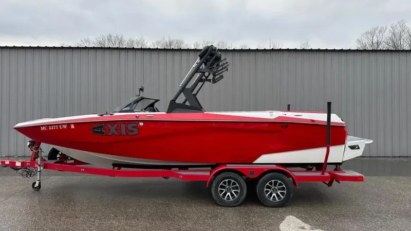 Slide: The Image of Red 2023 Axis A225 boat on trailer, parked outdoors. - 5