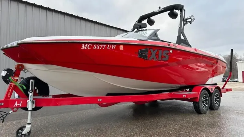 Slide: The Image of Red 2023 Axis A225 boat on trailer, parked outdoors. - 6