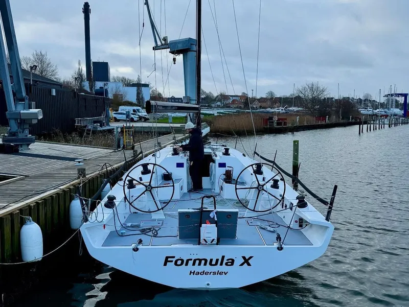 Slide: The Image of Sleek 2025 X-Yachts XR-41 sailboat docked, labeled "Formula X" in Haderslev marina. - 5