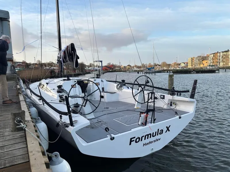 Slide: The Image of 2025 X-Yachts XR-41 sailboat docked, featuring dual steering wheels and sleek design. - 7