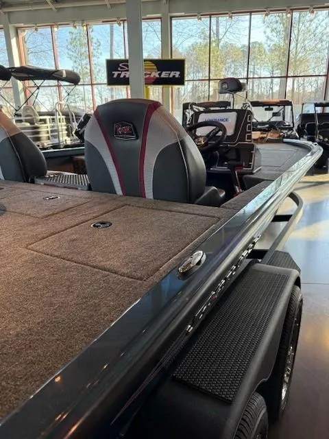 Slide: The Image of 2025 Ranger ALPHA 208 boat interior with seating and dashboard in showroom. - 2