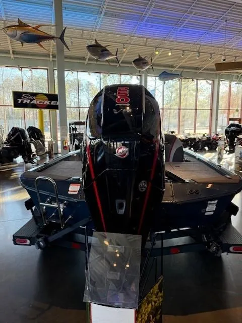 Slide: The Image of 2025 Ranger ALPHA 208 boat displayed indoors with mounted motor. - 3