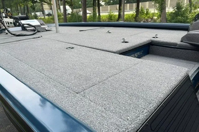 Slide: The Image of 2025 Ranger ALPHA 208 boat deck with carpeted surface and storage compartments. - 8