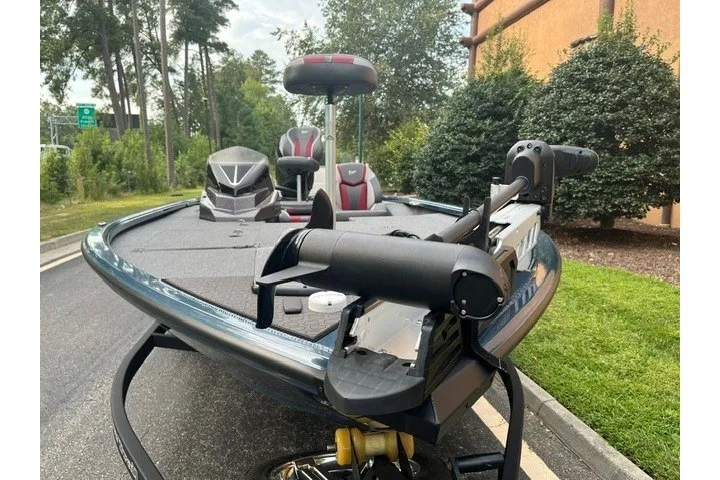 Slide: The Image of 2025 Ranger ALPHA 208 boat with advanced seating and equipment, parked outdoors. - 2