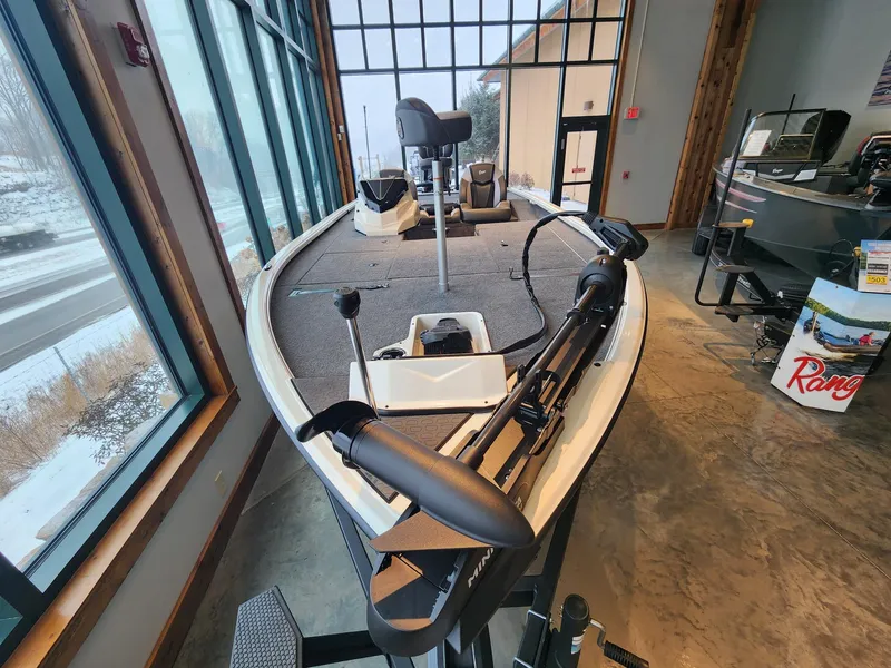 Slide: The Image of 2025 Ranger ALPHA 208 boat displayed indoors, featuring modern design and equipment. - 2