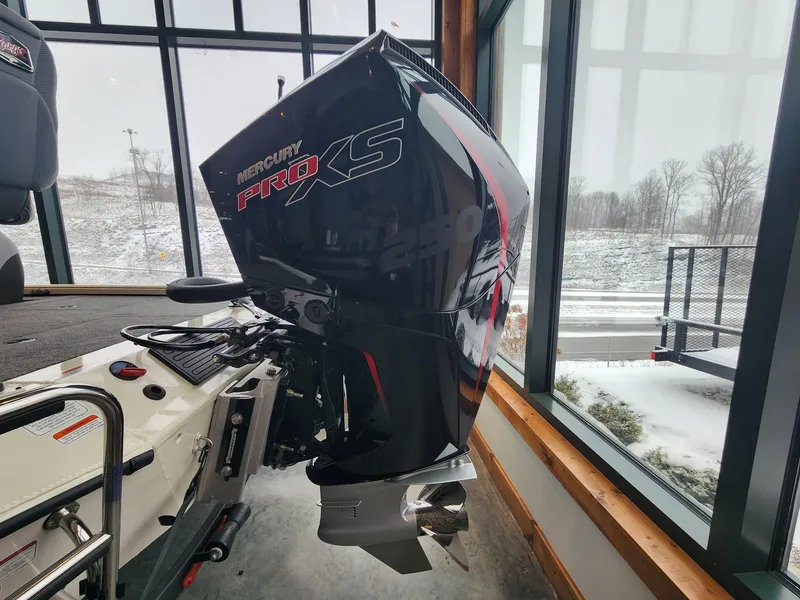 Slide: The Image of Ranger ALPHA 208 boat with Mercury Pro XS engine, displayed indoors, snowy landscape outside. - 6