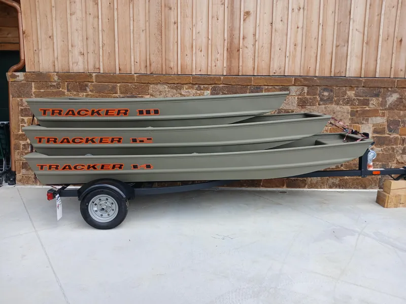 Slide: The Image of 2025 Tracker Grizzly 1236 Utility boats stacked on a trailer. - 31