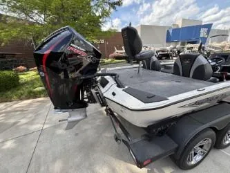 Slide: The Image of 2025 Ranger ALPHA 208 boat with powerful outboard motor, parked outdoors. - 2