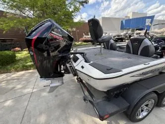 Slide: The Image of 2025 Ranger ALPHA 208 boat with powerful outboard motor, parked outdoors. - 3
