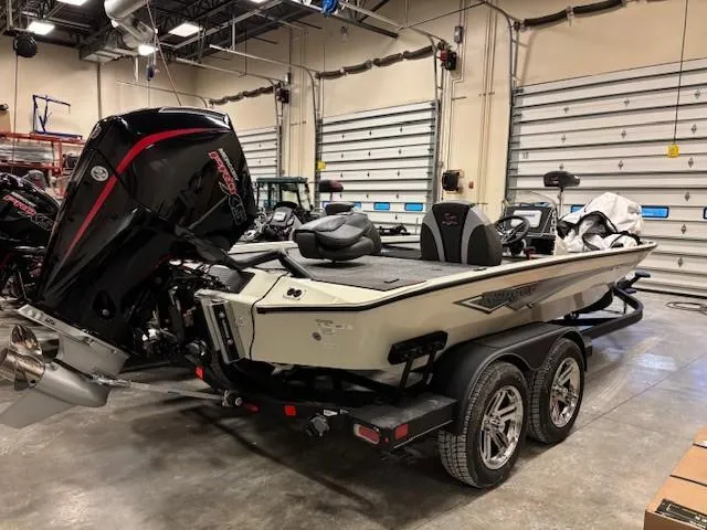 The Image of 2025 Ranger ALPHA 208 boat in a garage, featuring a powerful outboard motor. - 0