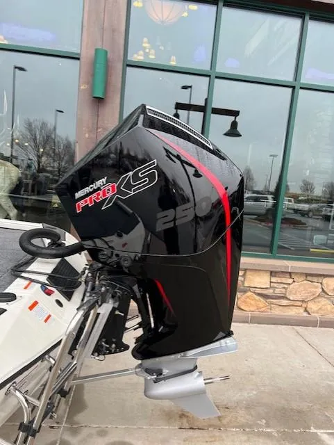 Slide: The Image of 2025 Ranger ALPHA 208 boat with Mercury Pro XS outboard motor, parked outside a building. - 3