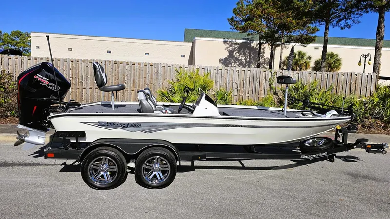 Slide: The Image of 2025 Ranger ALPHA 208 boat on trailer, parked outdoors, sunny day. - 4