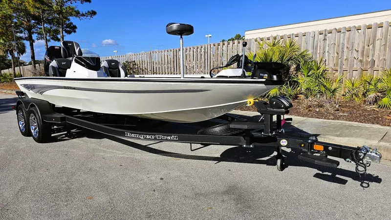Slide: The Image of 2025 Ranger ALPHA 208 boat on trailer, parked outdoors, sunny day. - 5