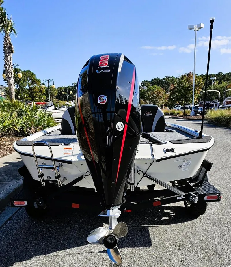 Slide: The Image of 2025 Ranger ALPHA 208 boat with powerful outboard motor, parked outdoors. - 6