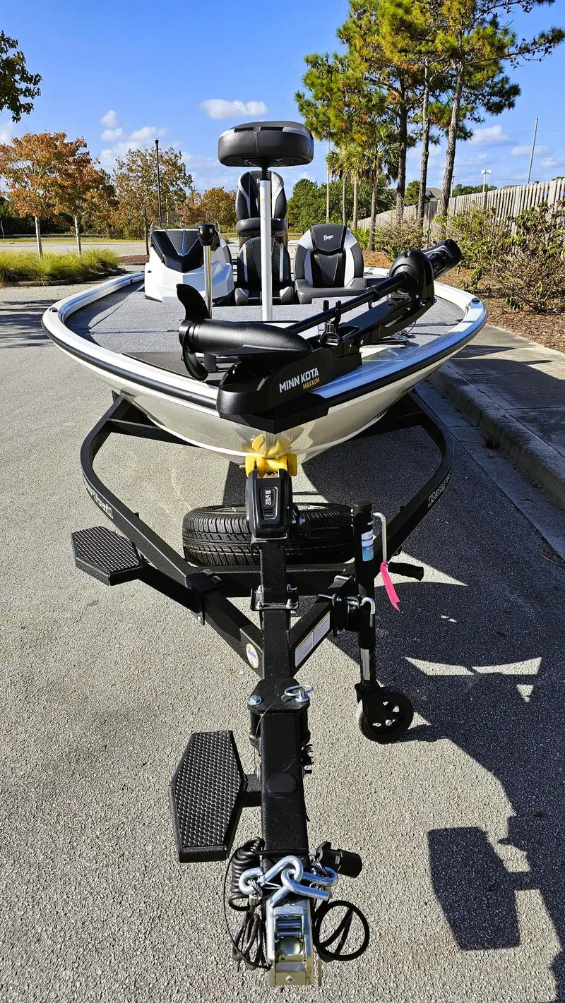 Slide: The Image of 2025 Ranger ALPHA 208 boat on trailer, parked on sunny street. - 8