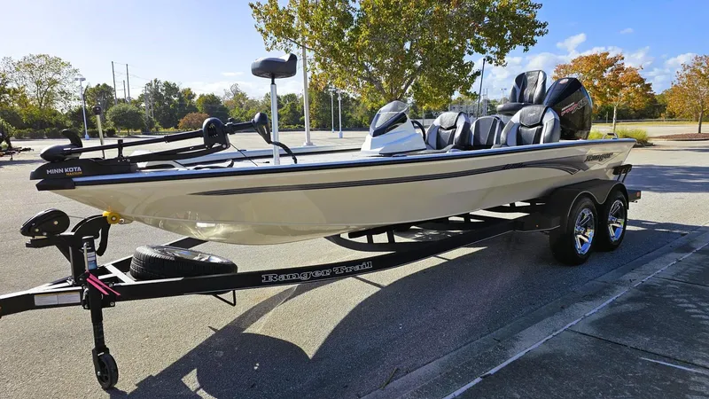 Slide: The Image of 2025 Ranger ALPHA 208 boat on trailer in sunny parking lot. - 9