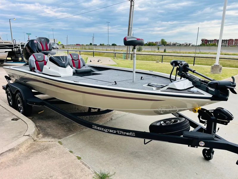 Slide: The Image of 2025 Ranger ALPHA 208 fishing boat on trailer, parked outdoors. - 2