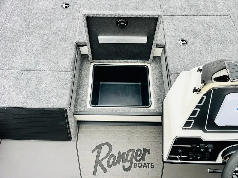 Slide: The Image of Ranger ALPHA 208 boat interior, featuring storage compartment and control panel, 2025 model. - 24