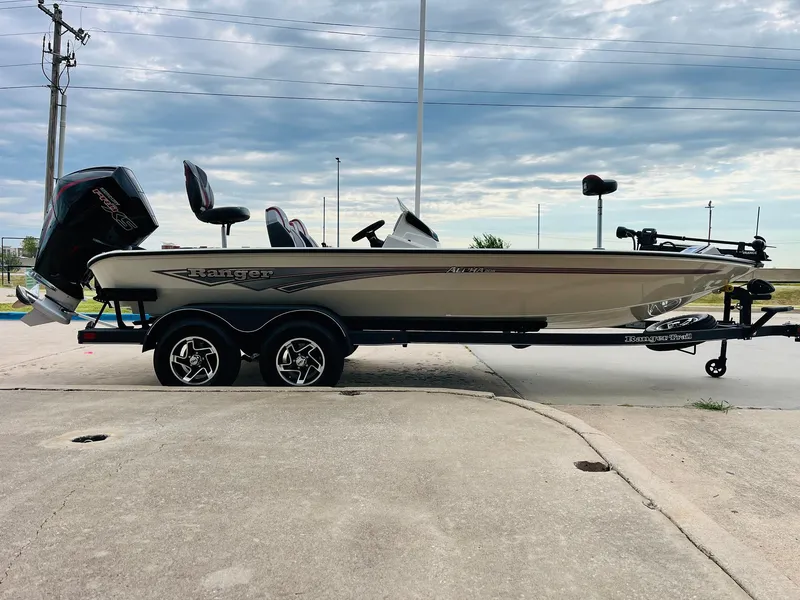 Slide: The Image of 2025 Ranger ALPHA 208 boat on trailer, side view under cloudy sky. - 3