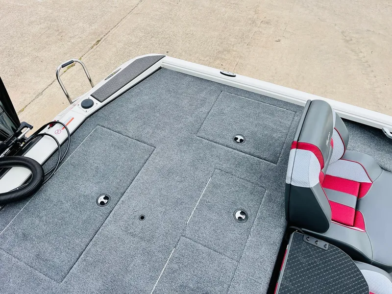 Slide: The Image of 2025 Ranger ALPHA 208 boat deck with gray carpet and red-accented seating. - 40