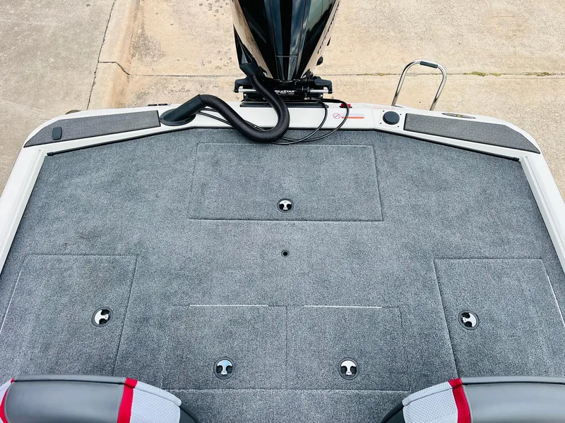 Slide: The Image of 2025 Ranger ALPHA 208 boat deck with carpeted surface and storage compartments. - 46