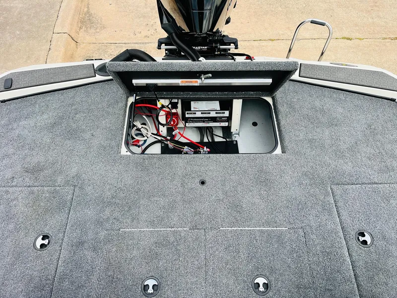 Slide: The Image of Ranger ALPHA 208 boat deck with open hatch, revealing wiring and battery compartment, 2025 model. - 47