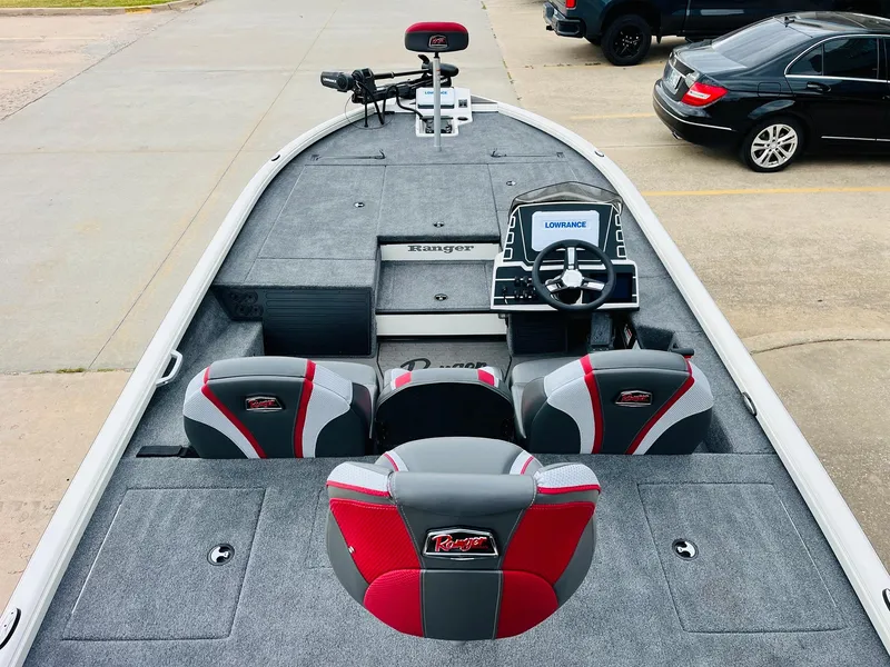 Slide: The Image of 2025 Ranger ALPHA 208 boat interior with red and gray seating, steering console, and electronics. - 8