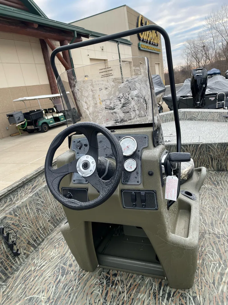 Slide: The Image of 2025 Tracker Grizzly 1860 CC boat console with steering wheel and gauges. - 3