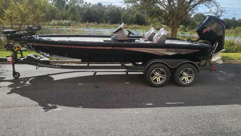 Slide: The Image of 2025 Ranger ALPHA 208 boat on trailer, parked outdoors, side view. - 3