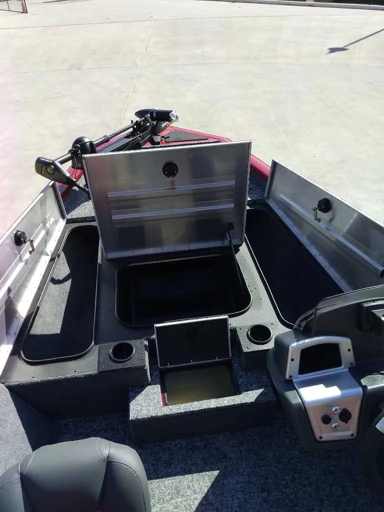 Slide: The Image of 2025 Tracker Pro Team 175 boat interior with open storage compartments and control panel. - 7