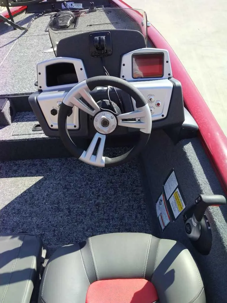 Slide: The Image of 2025 Tracker Pro Team 175 boat dashboard with steering wheel and control panels. - 8