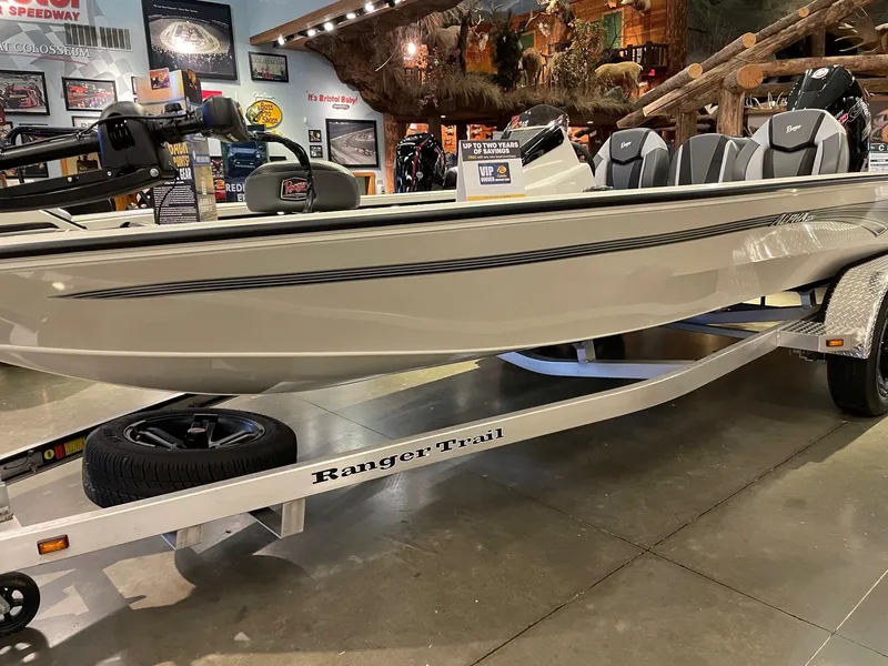 The Image of 2025 Ranger ALPHA 208 boat on display with trailer in showroom. - 0