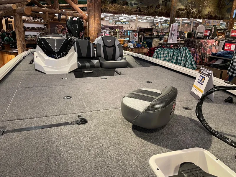 Slide: The Image of 2025 Ranger ALPHA 208 boat interior with seating and carpeted deck in showroom. - 2