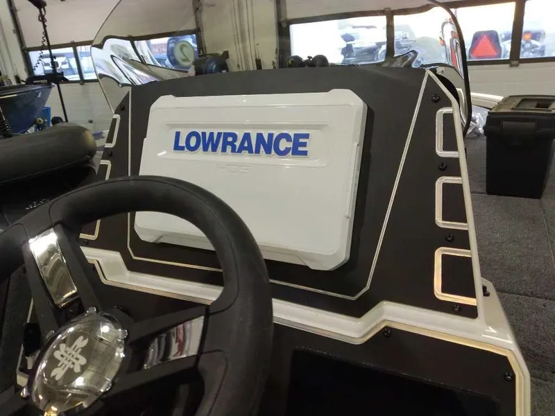 Slide: The Image of Steering wheel and Lowrance display on 2025 Ranger ALPHA 208 boat dashboard. - 6