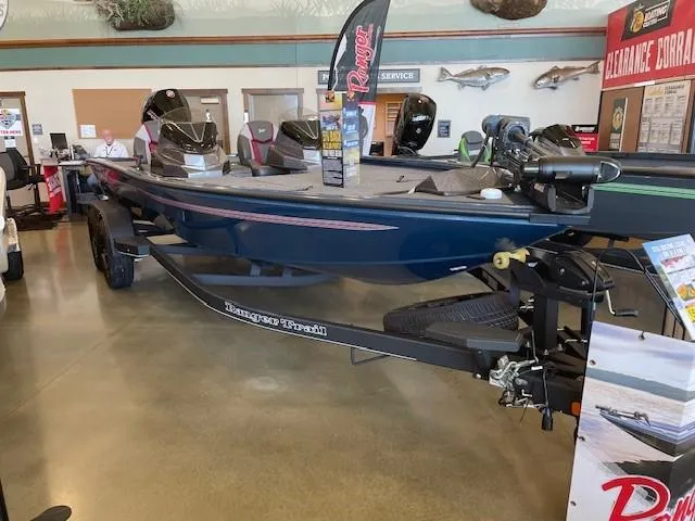 The Image of 2025 Ranger ALPHA 208 boat on trailer outside a showroom. - 0