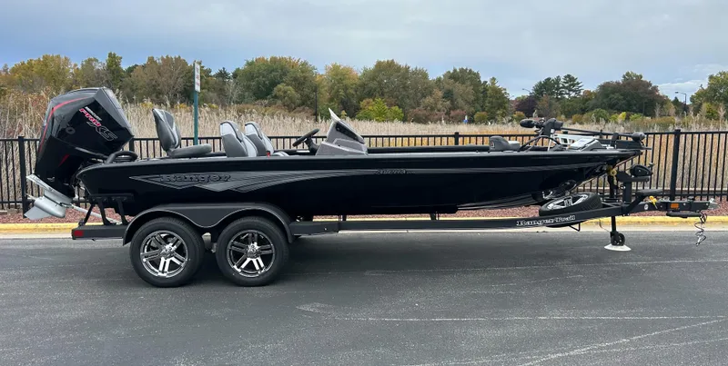The Image of 2025 Ranger ALPHA 208 boat on trailer, sleek black design, parked outdoors. - 0