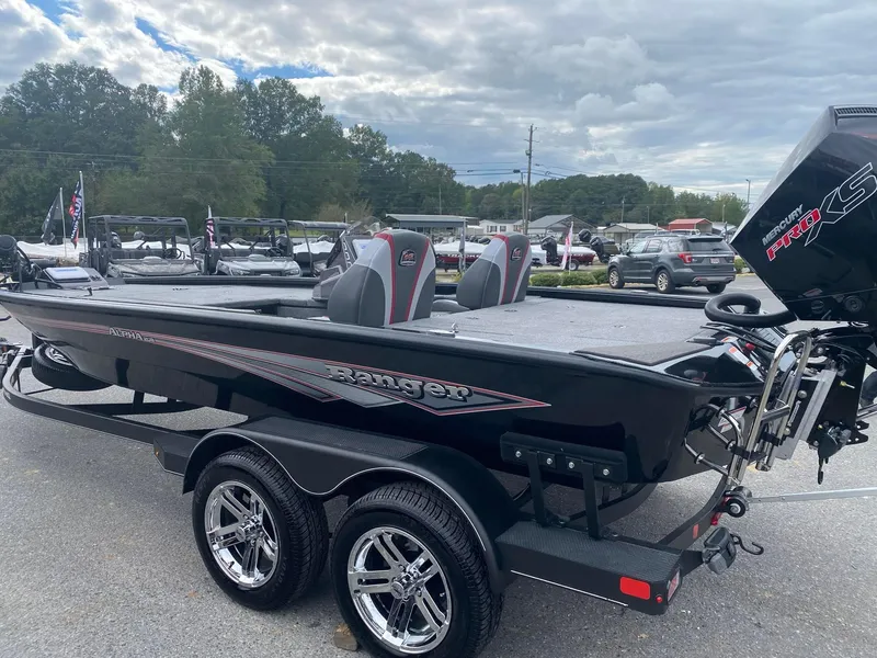Slide: The Image of 2025 Ranger ALPHA 208 boat on trailer, sleek design, parked outdoors. - 4