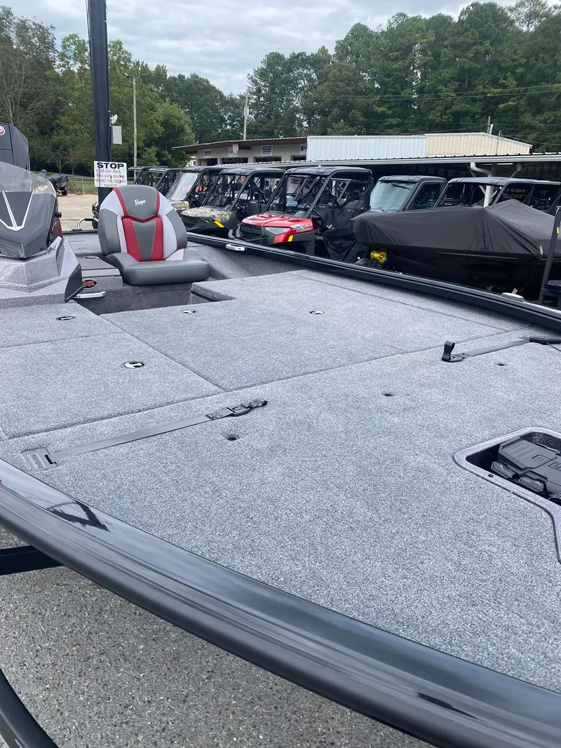 Slide: The Image of 2025 Ranger ALPHA 208 boat with spacious deck, parked outdoors. - 9